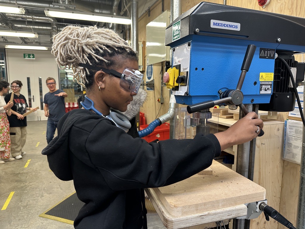 Working at a pillar drill in the workshop
