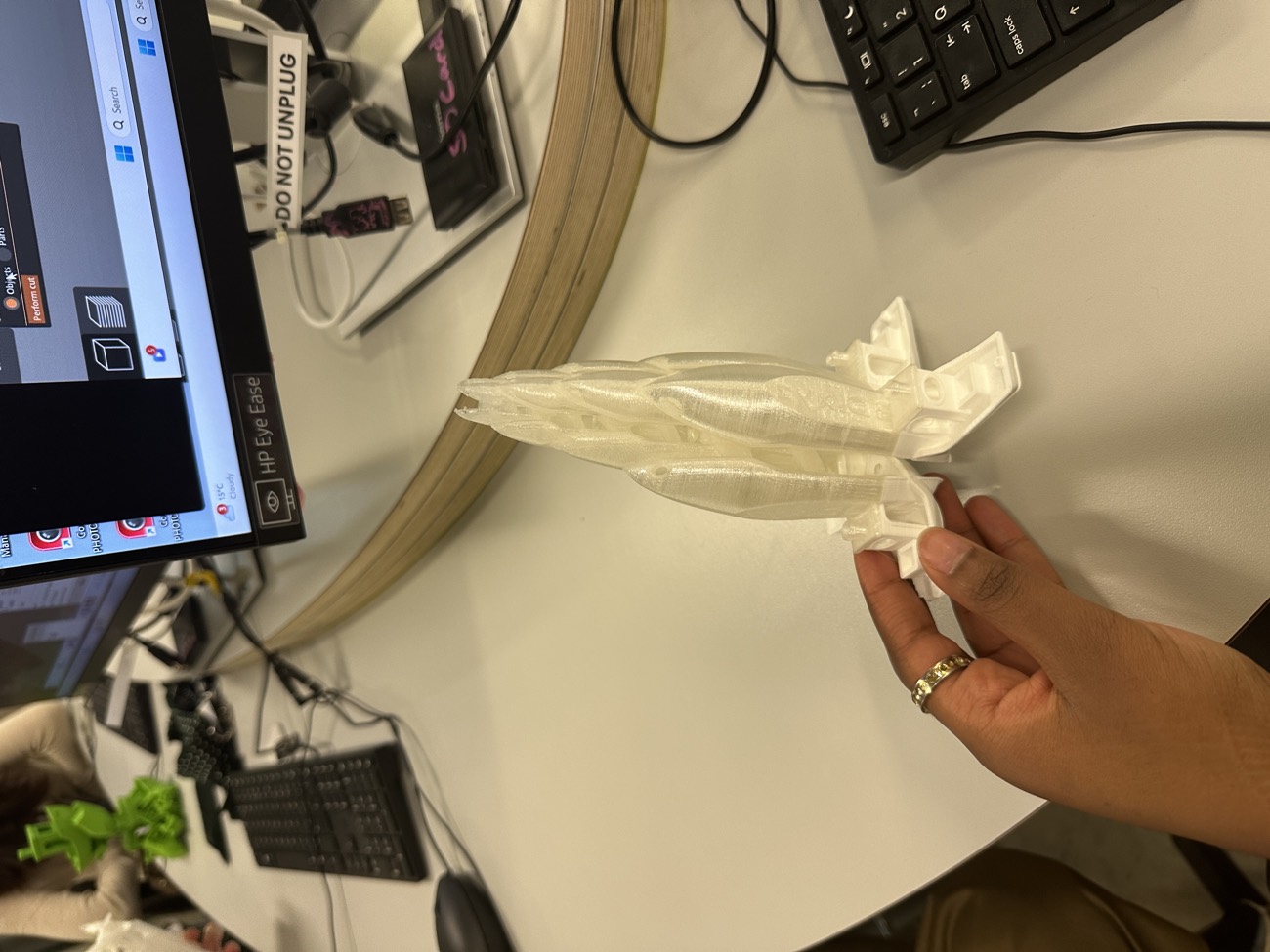 Hand holding a white 3D-printed form